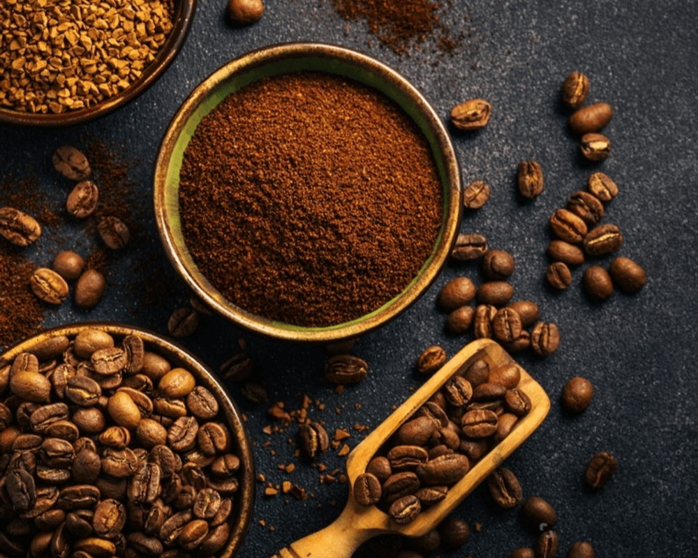 Coffee grounds on a table surrounded by coffee beans